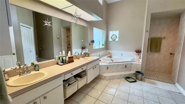 a view of a white house with a yard and potted plants