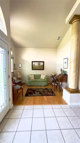 a living room with furniture and a large window