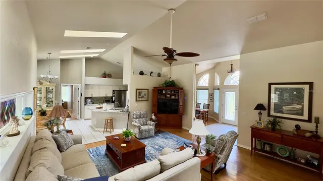 a kitchen with stainless steel appliances kitchen island granite countertop a table and chairs in it
