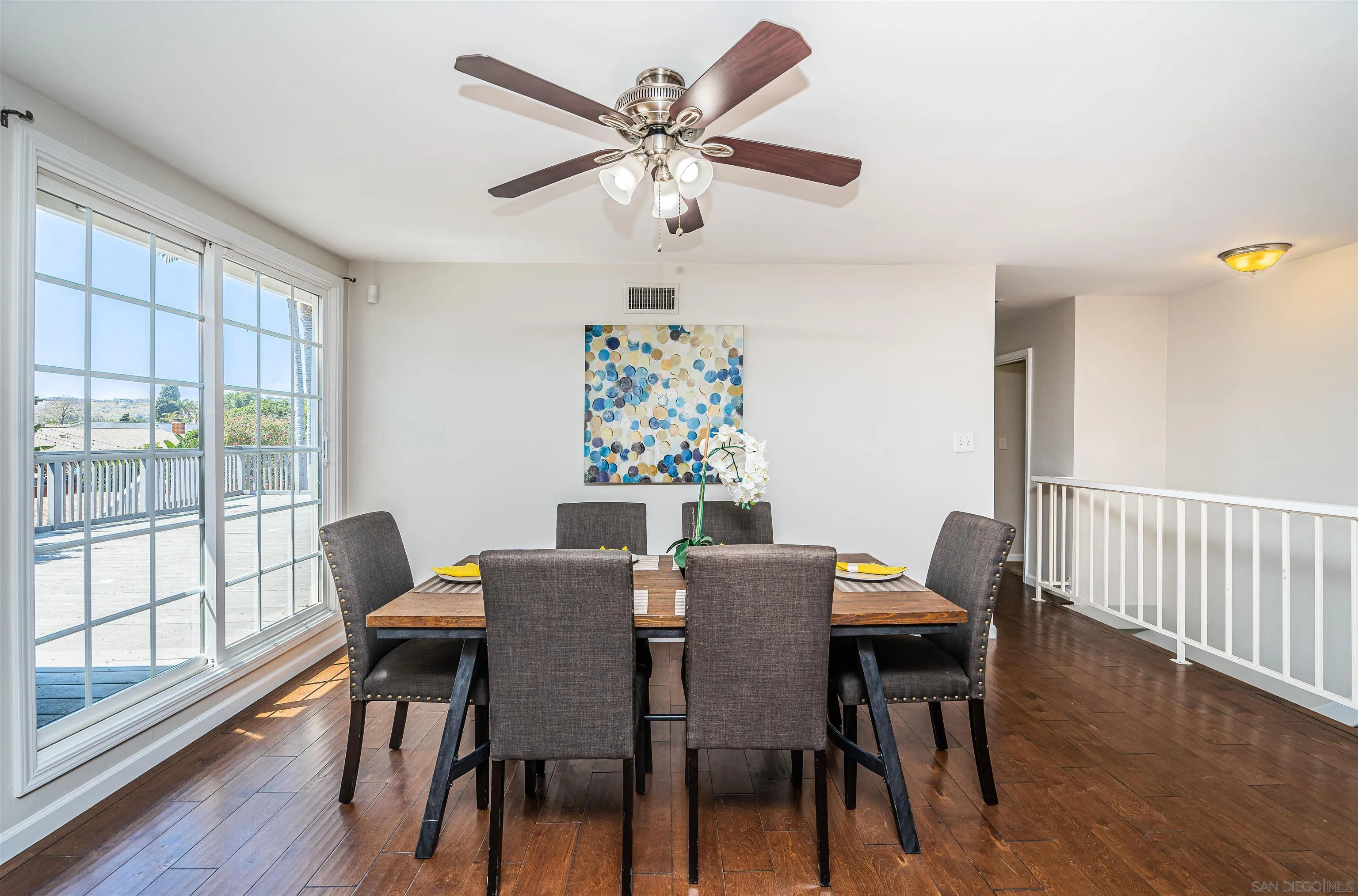 8410 Roy Street Lemon Grove, CA 91945 - Photo 12 of 40 a view of a dining room with furniture a chandelier and wooden floor