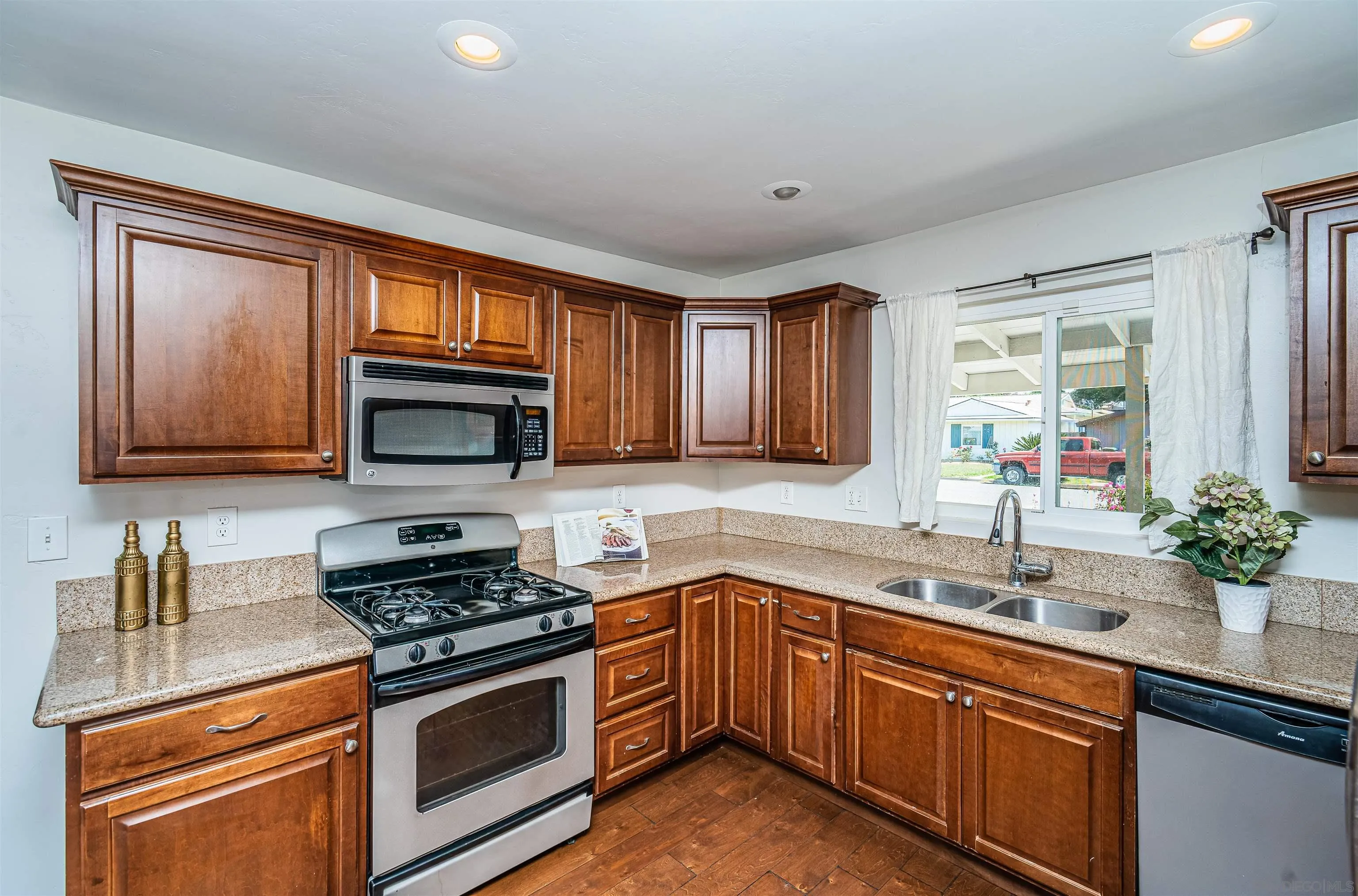8410 Roy Street Lemon Grove, CA 91945 - Photo 14 of 40 a kitchen with stainless steel appliances granite countertop a sink stove and microwave