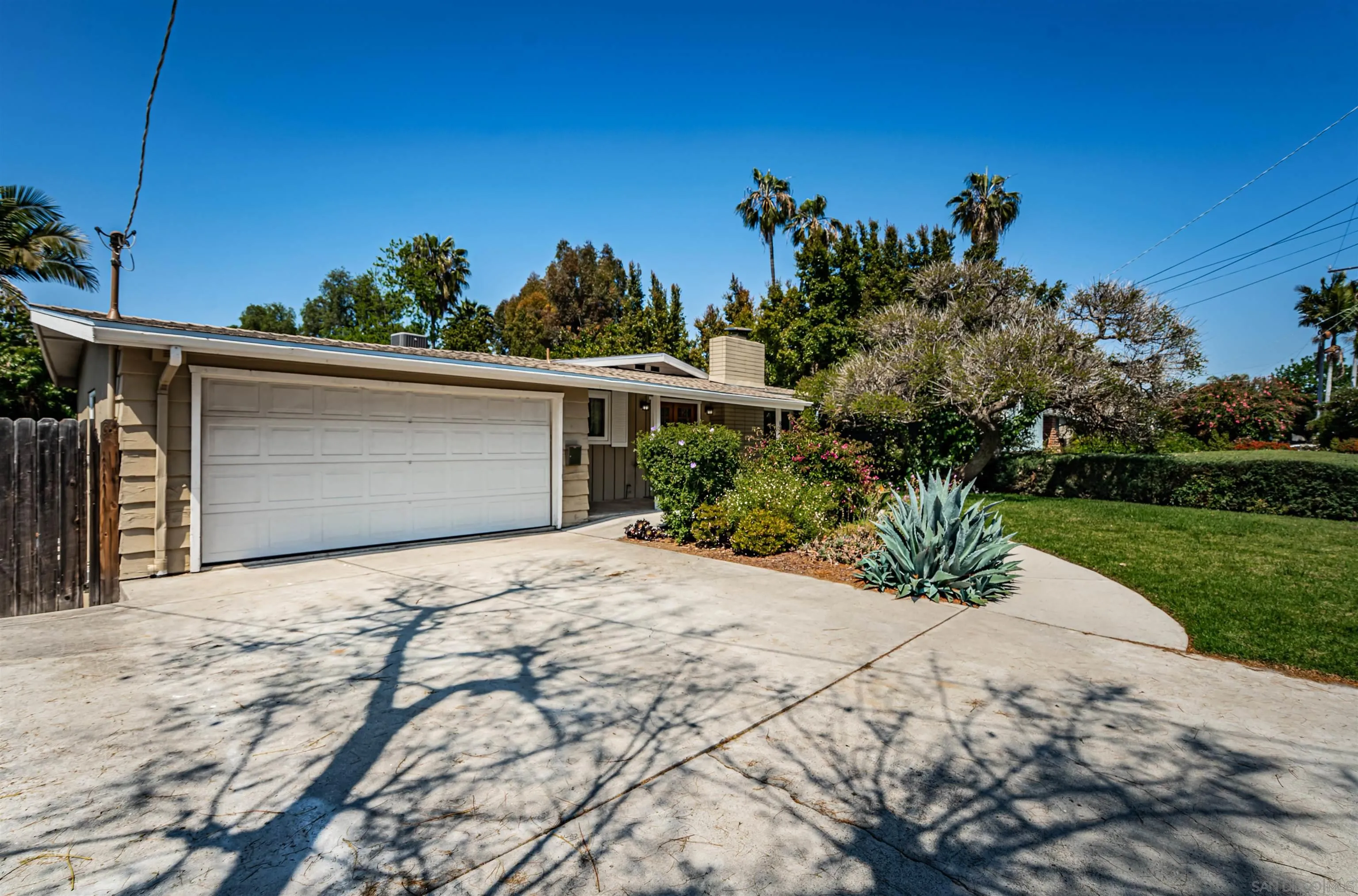 8410 Roy Street Lemon Grove, CA 91945 - Photo 2 of 40 a front view of a house with a yard and garage