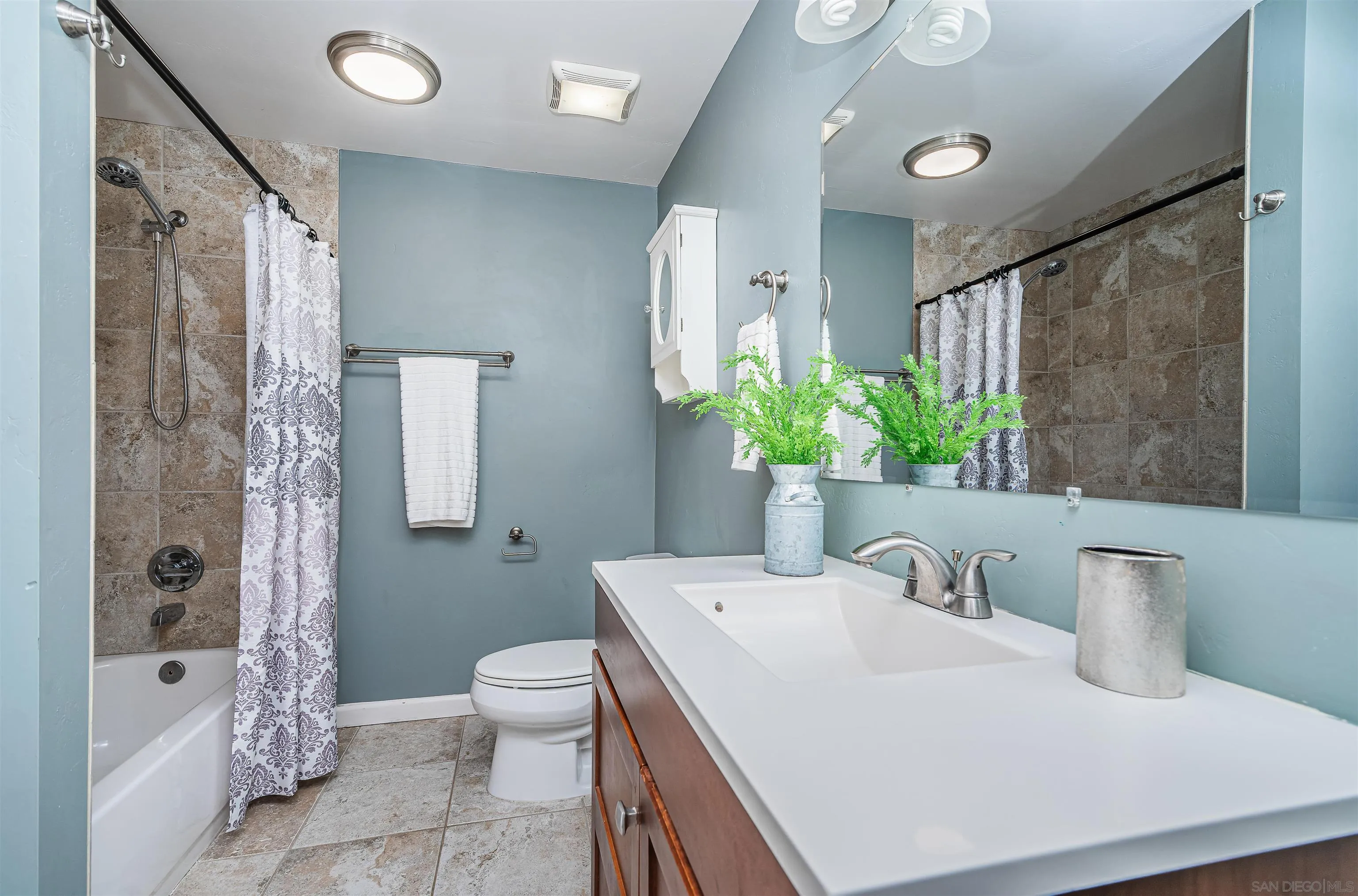 8410 Roy Street Lemon Grove, CA 91945 - Photo 22 of 40 a bathroom with a granite countertop sink a toilet and shower