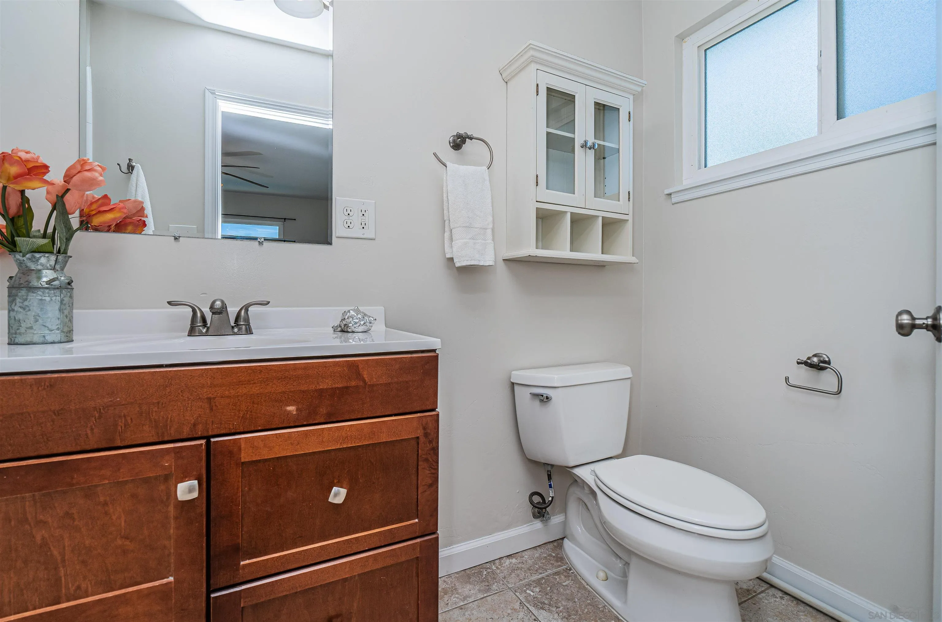 8410 Roy Street Lemon Grove, CA 91945 - Photo 25 of 40 a bathroom with a toilet sink and mirror