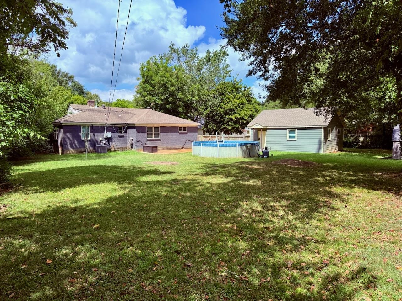 458 Gerald Road Memphis, TN 38122 - Photo 7 of 34 a view of a house with a big yard and large trees