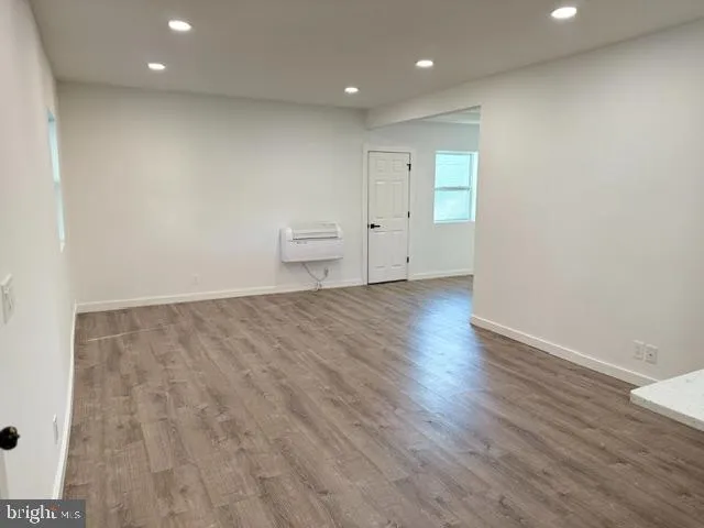 a view of a room with wooden floor and window
