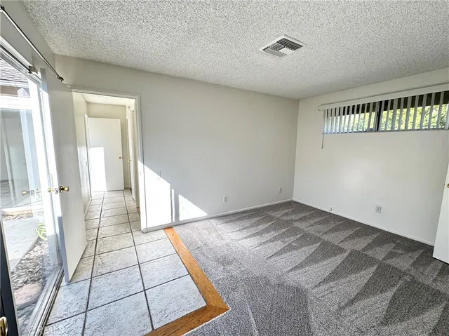 a view of an empty room and a window