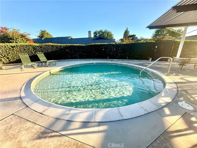 a view of a swimming pool with a chairs