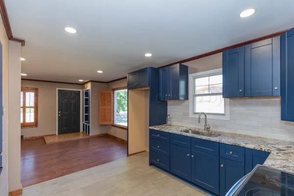 a kitchen with stainless steel appliances granite countertop a refrigerator and a stove top oven