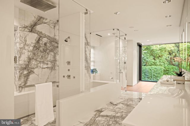 a bathroom with a tub sink and mirror