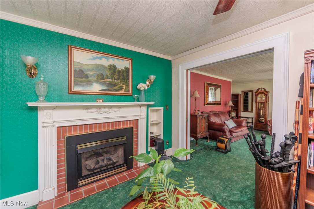 2550 North Ridge Road Vermilion, OH 44089 - Photo 24 of 50 Living room featuring a brick fireplace and ornamental molding