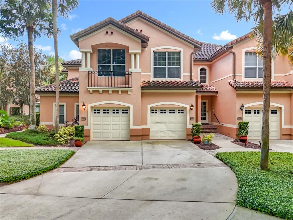 503 Camino Real, Unit 503 Howey-in-the-Hills, FL 34737 - Photo 1 of 65 a front view of a house with a yard and garage