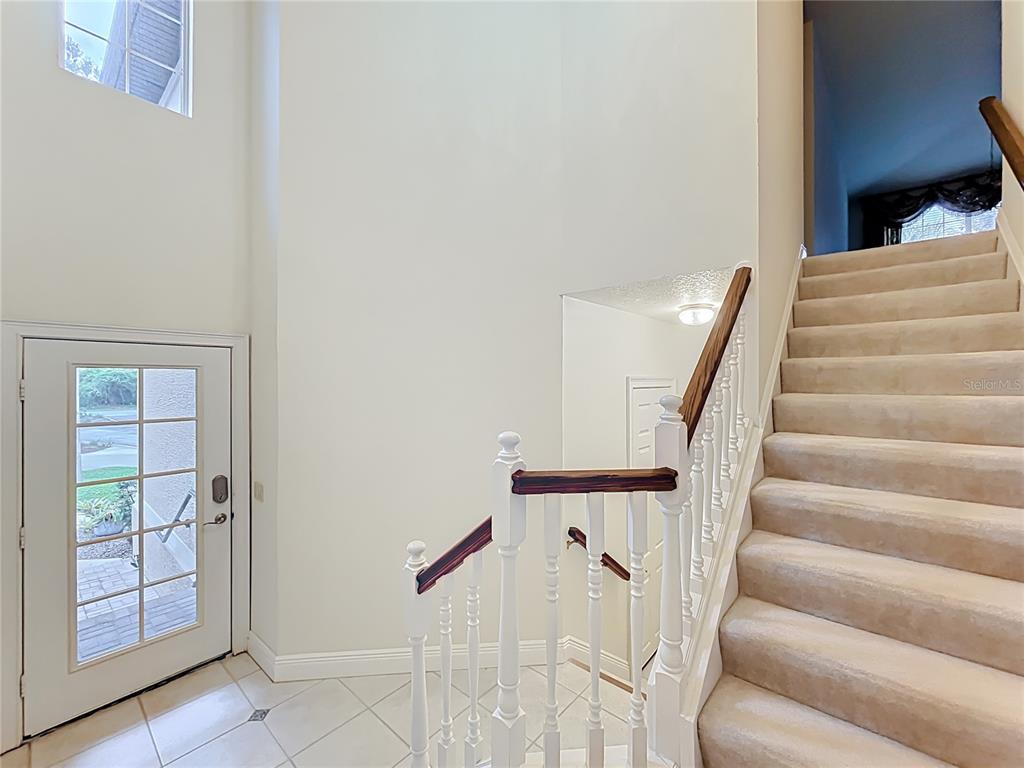 503 Camino Real, Unit 503 Howey-in-the-Hills, FL 34737 - Photo 11 of 65 a view of staircase with white walls