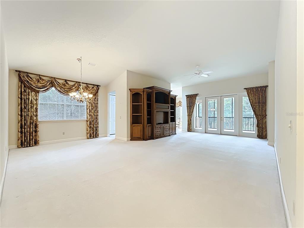 503 Camino Real, Unit 503 Howey-in-the-Hills, FL 34737 - Photo 12 of 65 a view of an empty room with a window and fireplace