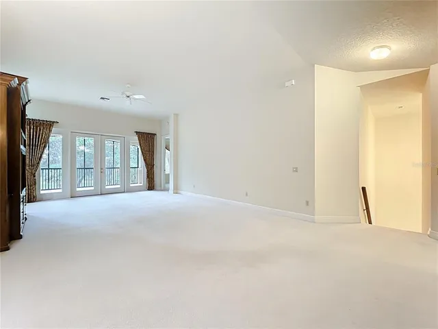 an empty room with closet and a window