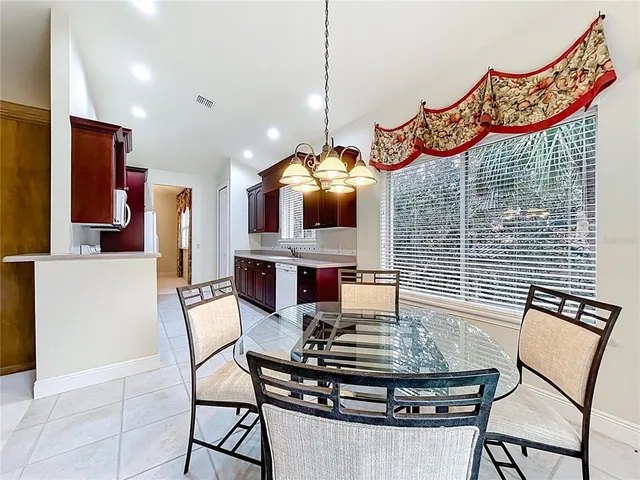 a stove top oven sitting inside of a kitchen with granite countertop wooden cabinets