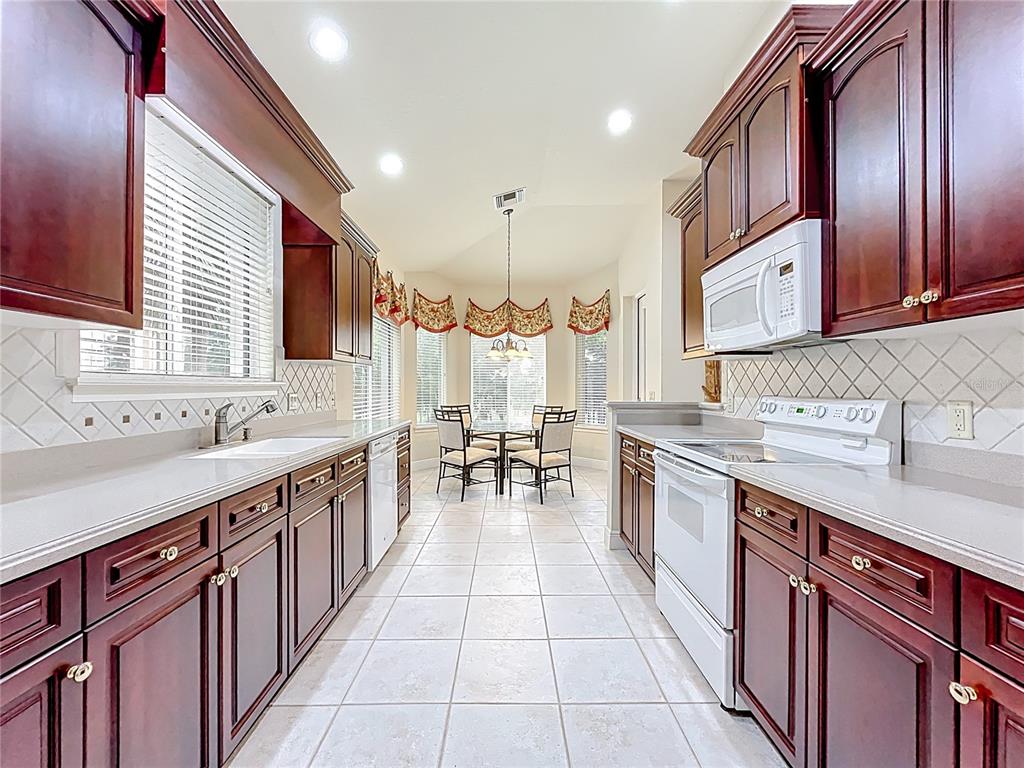 503 Camino Real, Unit 503 Howey-in-the-Hills, FL 34737 - Photo 22 of 65 a kitchen with stainless steel appliances granite countertop a sink stove and cabinets