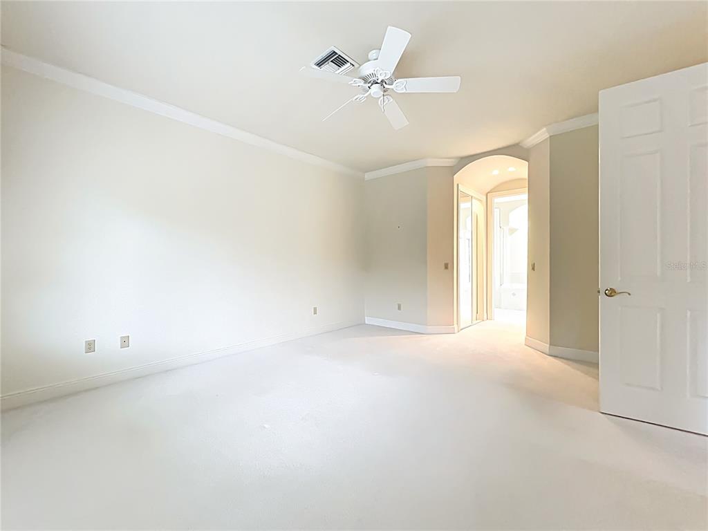 503 Camino Real, Unit 503 Howey-in-the-Hills, FL 34737 - Photo 23 of 65 an empty room with a window and a fan