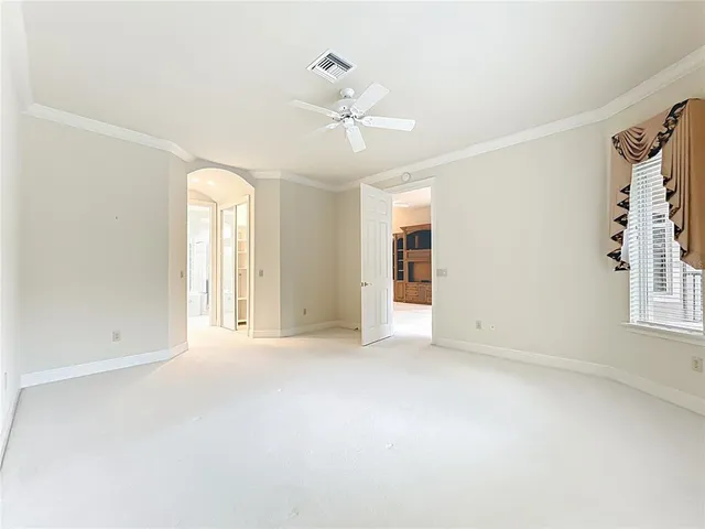 a view of walk in closet with empty racks