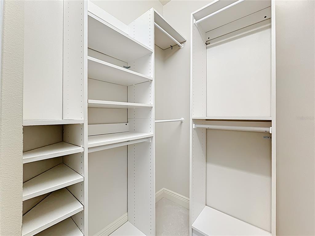 503 Camino Real, Unit 503 Howey-in-the-Hills, FL 34737 - Photo 28 of 65 a view of walk in closet with empty racks