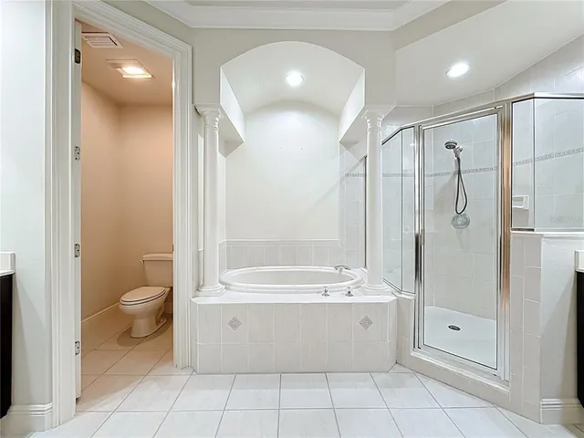 an empty room with chandelier fan and windows