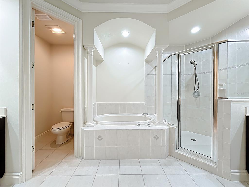 503 Camino Real, Unit 503 Howey-in-the-Hills, FL 34737 - Photo 29 of 65 a bathroom with a bathtub a toilet and a shower