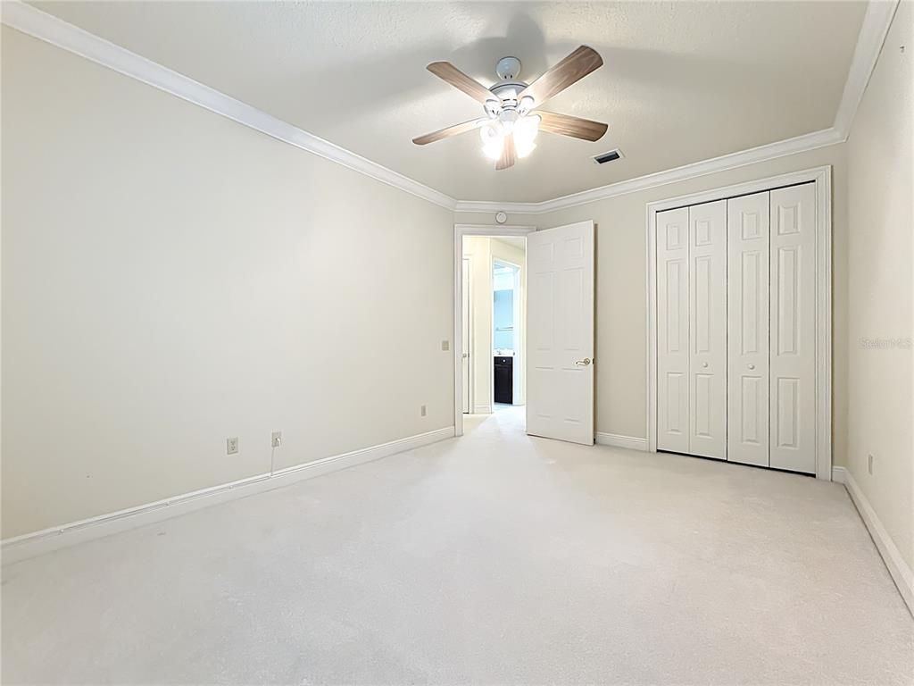 503 Camino Real, Unit 503 Howey-in-the-Hills, FL 34737 - Photo 34 of 65 an empty room with chandelier fan and windows