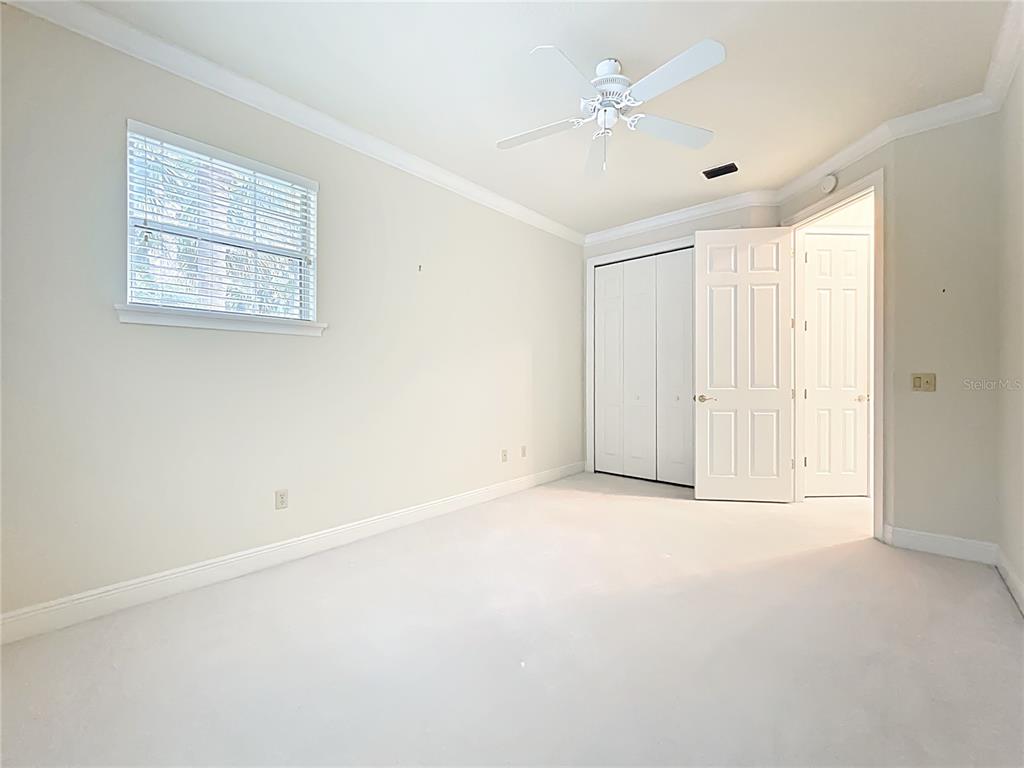 503 Camino Real, Unit 503 Howey-in-the-Hills, FL 34737 - Photo 37 of 65 an empty room with a ceiling fan and a window