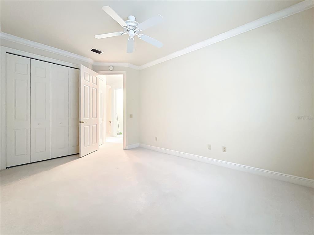 503 Camino Real, Unit 503 Howey-in-the-Hills, FL 34737 - Photo 38 of 65 an empty room with a ceiling fan and a window