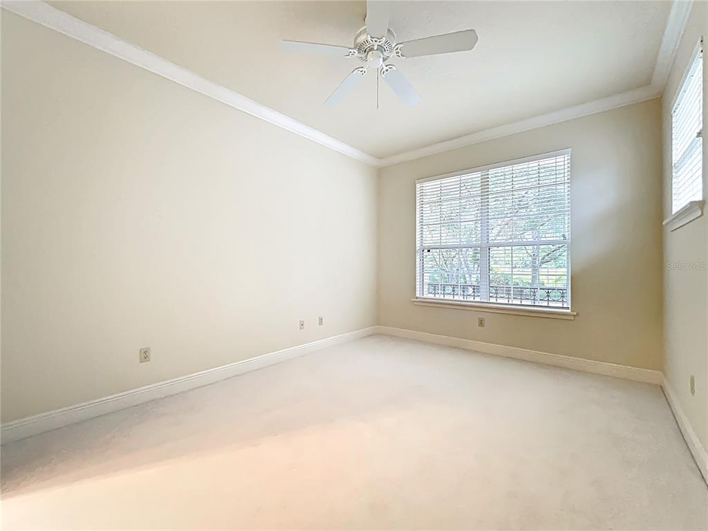 503 Camino Real, Unit 503 Howey-in-the-Hills, FL 34737 - Photo 39 of 65 an empty room with a window and ceiling fan