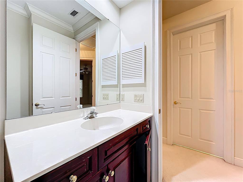 503 Camino Real, Unit 503 Howey-in-the-Hills, FL 34737 - Photo 42 of 65 a bathroom with a sink vanity and a mirror