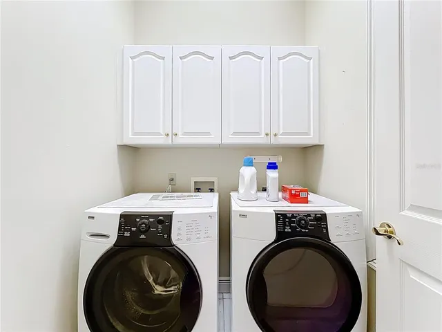 an aerial view of house with outdoor space and lake view