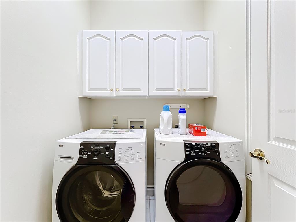 503 Camino Real, Unit 503 Howey-in-the-Hills, FL 34737 - Photo 43 of 65 a utility room with dryer and washer