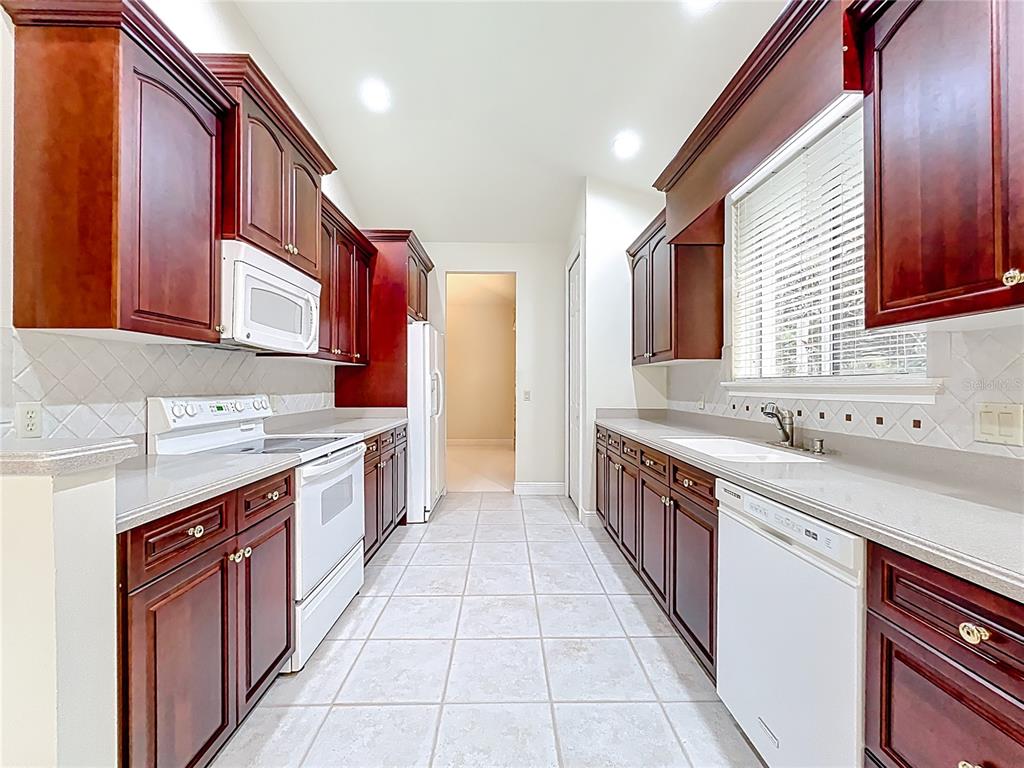 503 Camino Real, Unit 503 Howey-in-the-Hills, FL 34737 - Photo 5 of 65 a kitchen with a sink stove top oven and cabinets