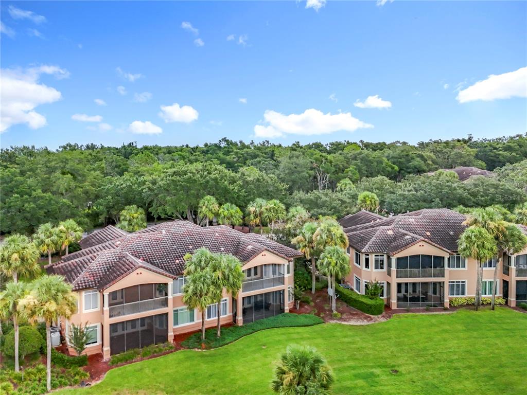 503 Camino Real, Unit 503 Howey-in-the-Hills, FL 34737 - Photo 52 of 65 a front view of a house with a garden