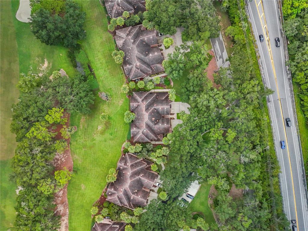 503 Camino Real, Unit 503 Howey-in-the-Hills, FL 34737 - Photo 55 of 65 an aerial view of residential house with outdoor space and trees all around