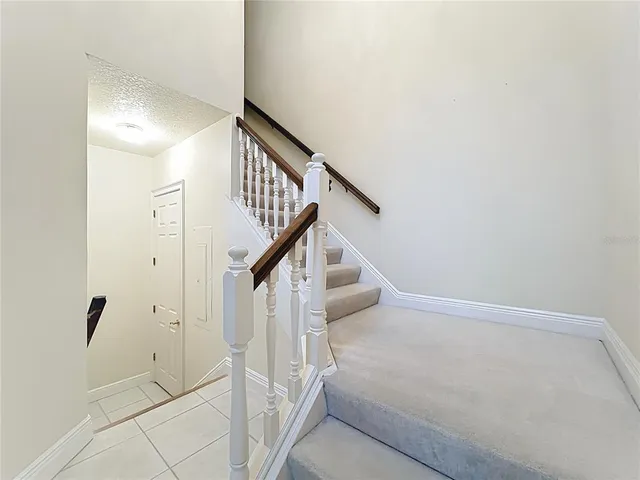 a view of an empty room with a window and fireplace