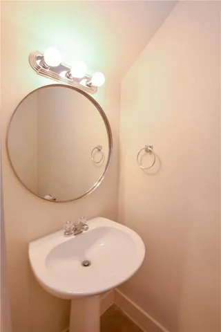 a bathroom with a sink and mirror