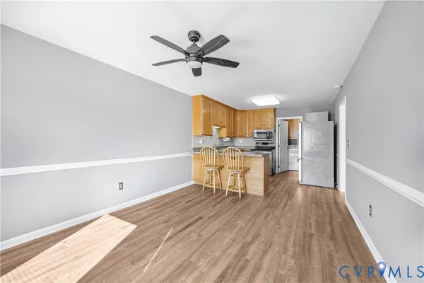 a view of a kitchen with wooden floor and a window