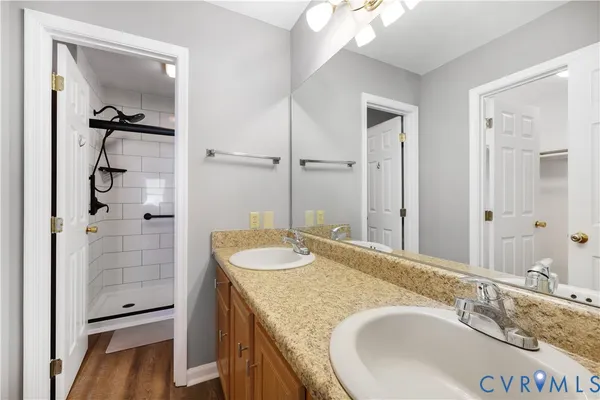 a bathroom with a granite countertop sink mirror and shower