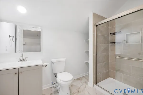 a bathroom with a toilet sink and shower
