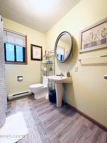 a bathroom with a toilet a sink and a mirror
