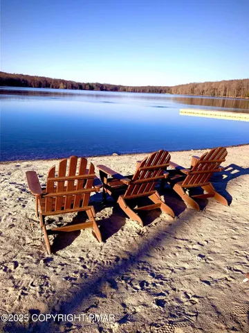a view of a lake with couches chairs
