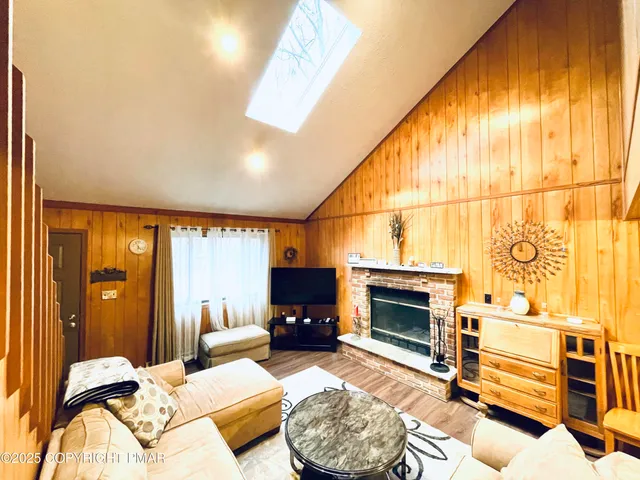 a bedroom with furniture a fireplace and a ceiling fan