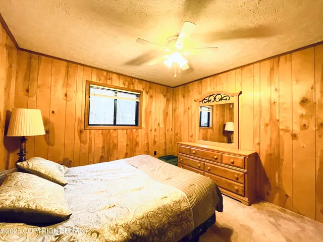 a bedroom with a bed and a night stand