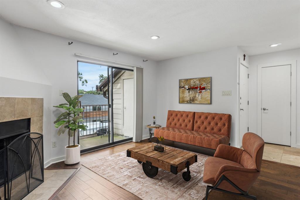 4777 Cedar Springs Road, Unit 6N Dallas, TX 75219 - Photo 3 of 26 a living room with furniture and a fireplace