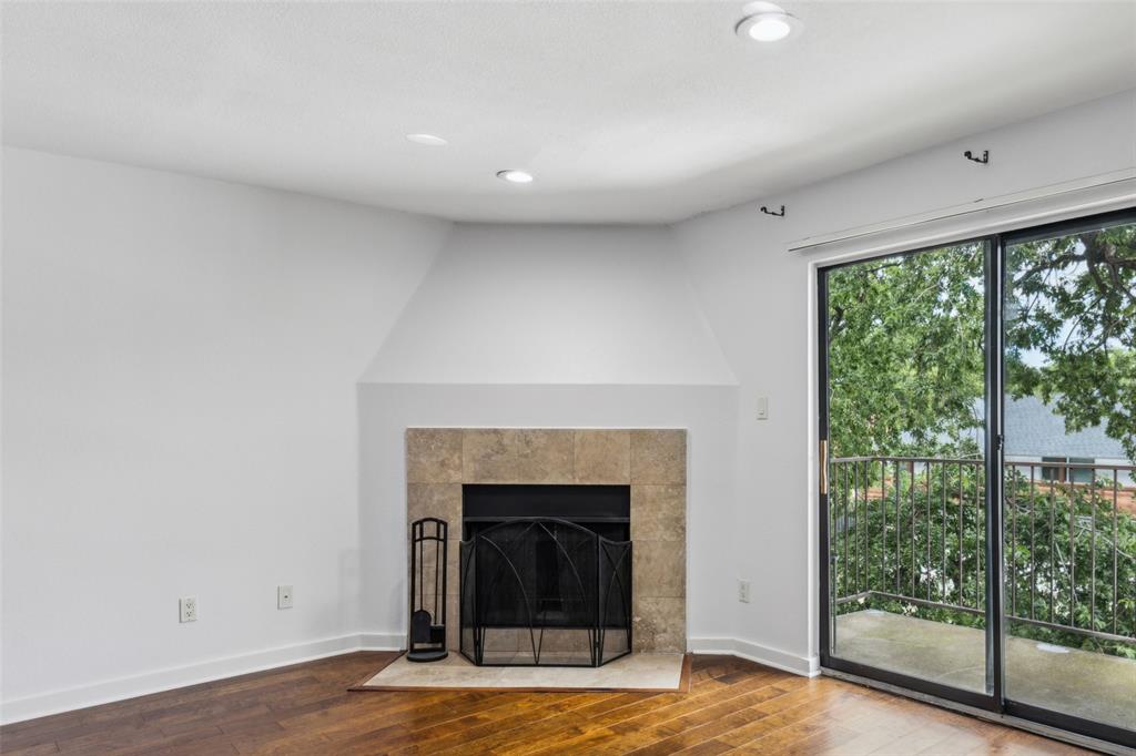4777 Cedar Springs Road, Unit 6N Dallas, TX 75219 - Photo 5 of 26 a view of a livingroom with a fireplace and window