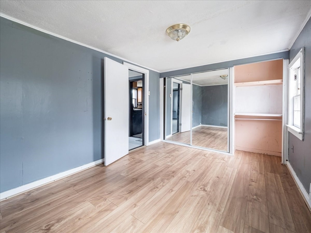 10 East Shore Road Holbrook, MA 02343 - Photo 12 of 30 a view of a hallway with wooden floor and a kitchen