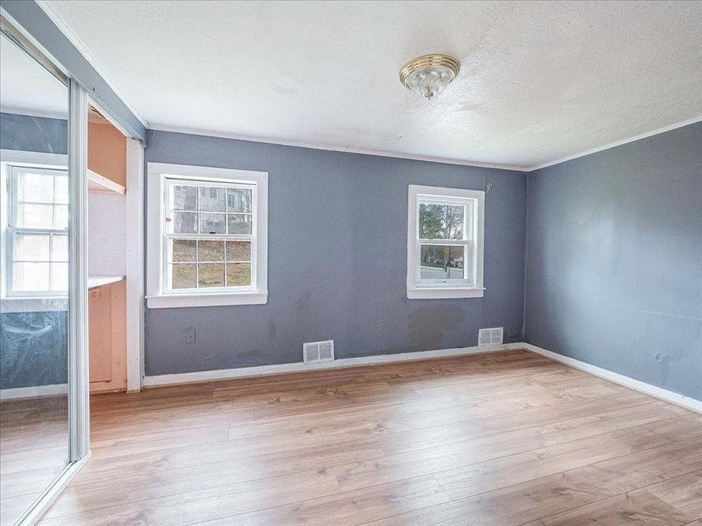 10 East Shore Road Holbrook, MA 02343 - Photo 13 of 30 a view of an empty room with wooden floor and a window