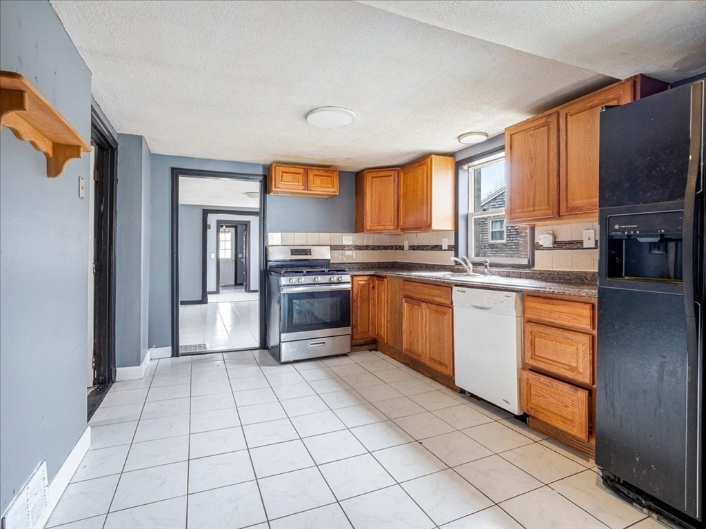 10 East Shore Road Holbrook, MA 02343 - Photo 14 of 30 a kitchen with stainless steel appliances granite countertop a stove sink and cabinets